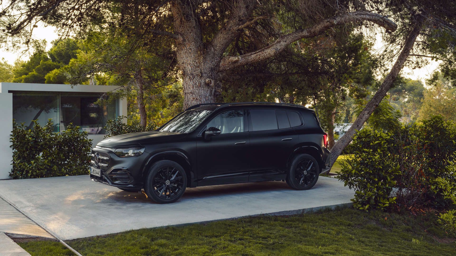 2026 Mercedes-Benz EQB - side profile view of a matte black 2026 Mercedes-Benz EQB parked outdoors - Mercedes-Benz Brampton - New car dealership in Brampton, Ontario
