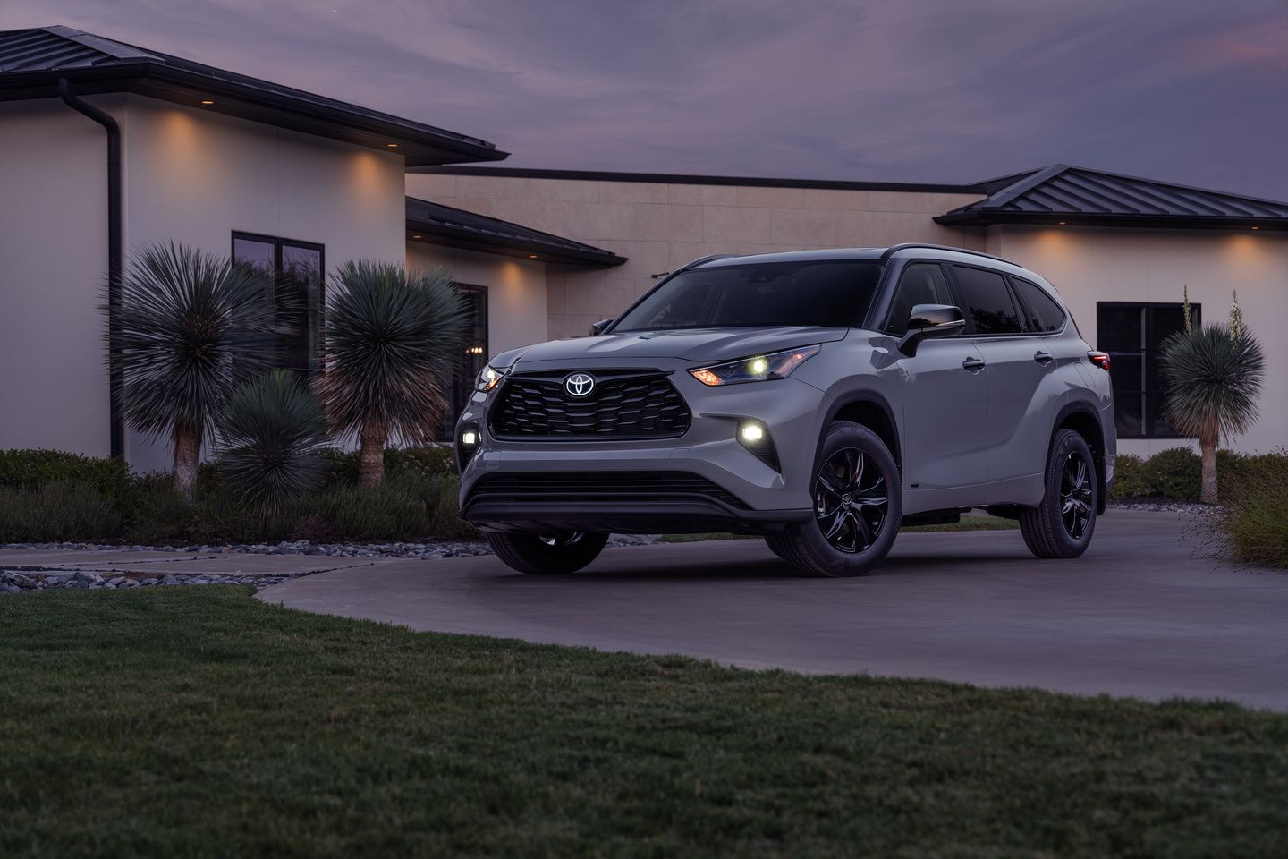 2026 Toyota Highlander - a grey 2026 Toyota Highlander parked in a driveway at dusk - Humberview Group - New car dealerships in Ontario