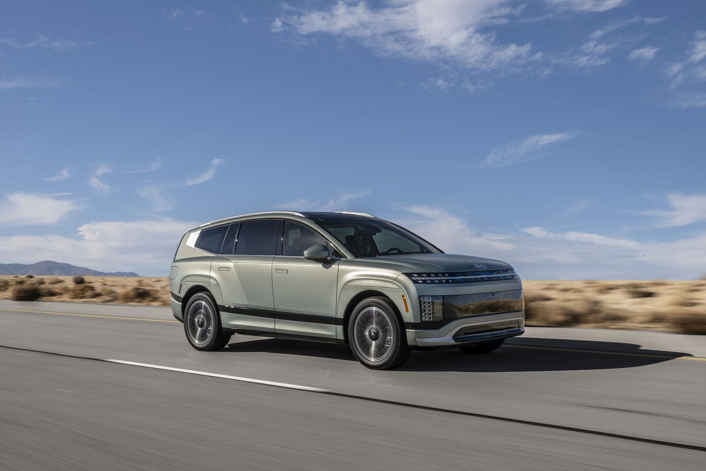 2026 Hyundai IONIQ 9 - a green 2026 Hyundai IONIQ 9 electric SUV driving on a desert highway - Humberview Group - New car dealerships in Ontario