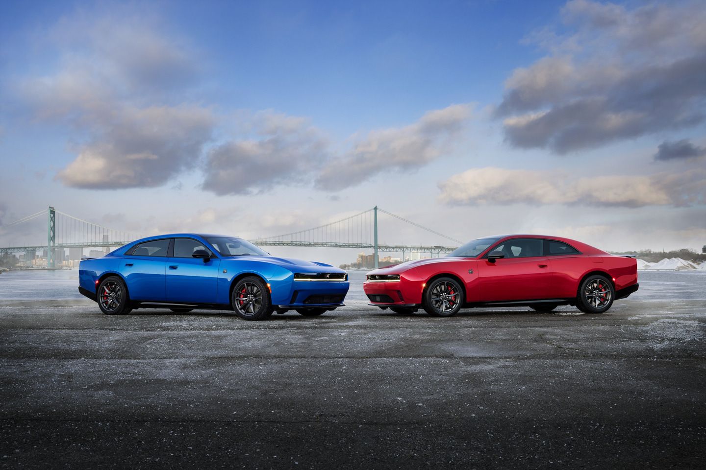 2026 Dodge Charger - a blue and a red 2026 Dodge Charger parked side-by-side near a waterfront - Humberview Group - New car dealerships in Ontario