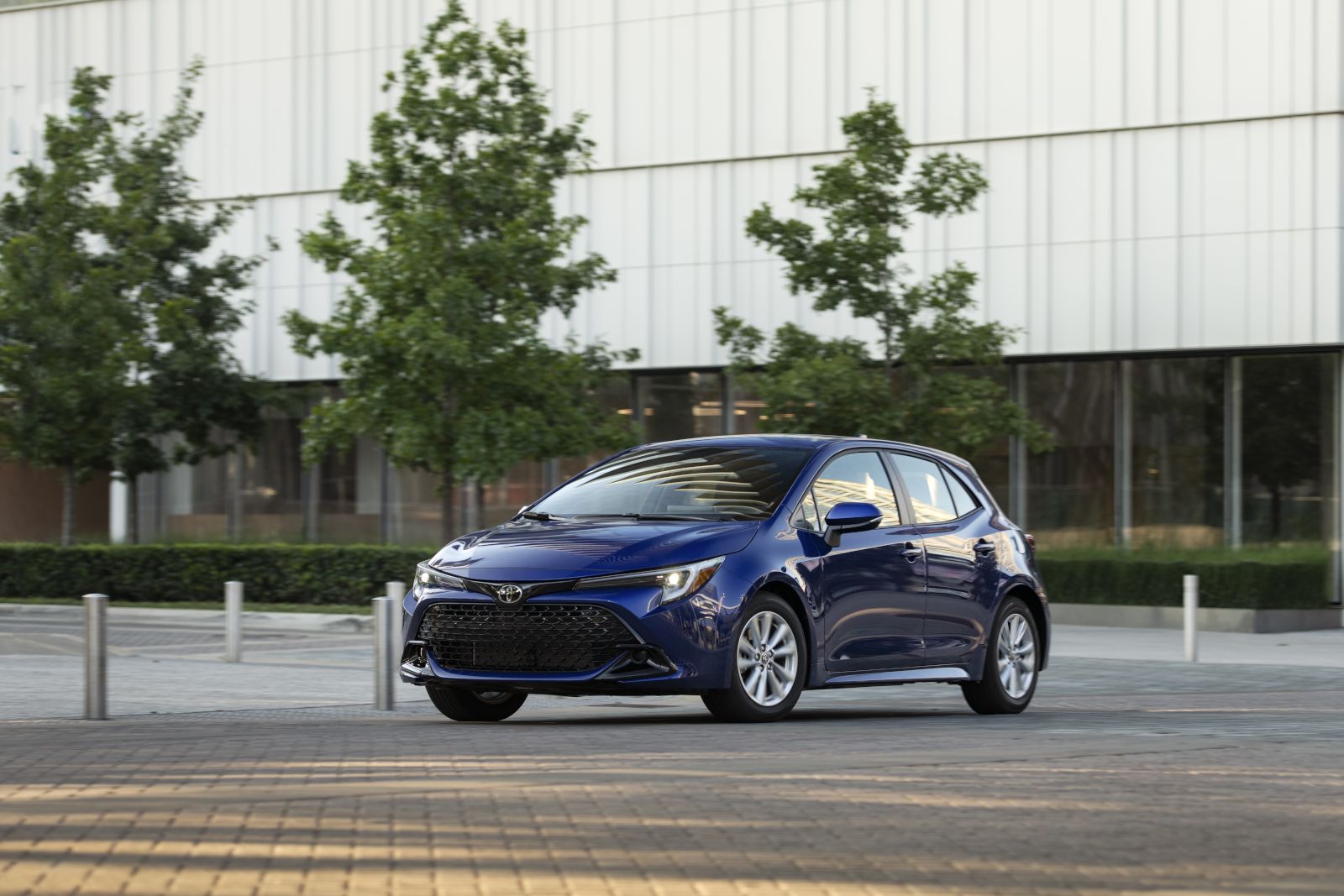 2026 Toyota Corolla Hatchback - a blue 2026 Toyota Corolla Hatchback parked near a modern white building - Humberview Group - New car dealerships in Ontario