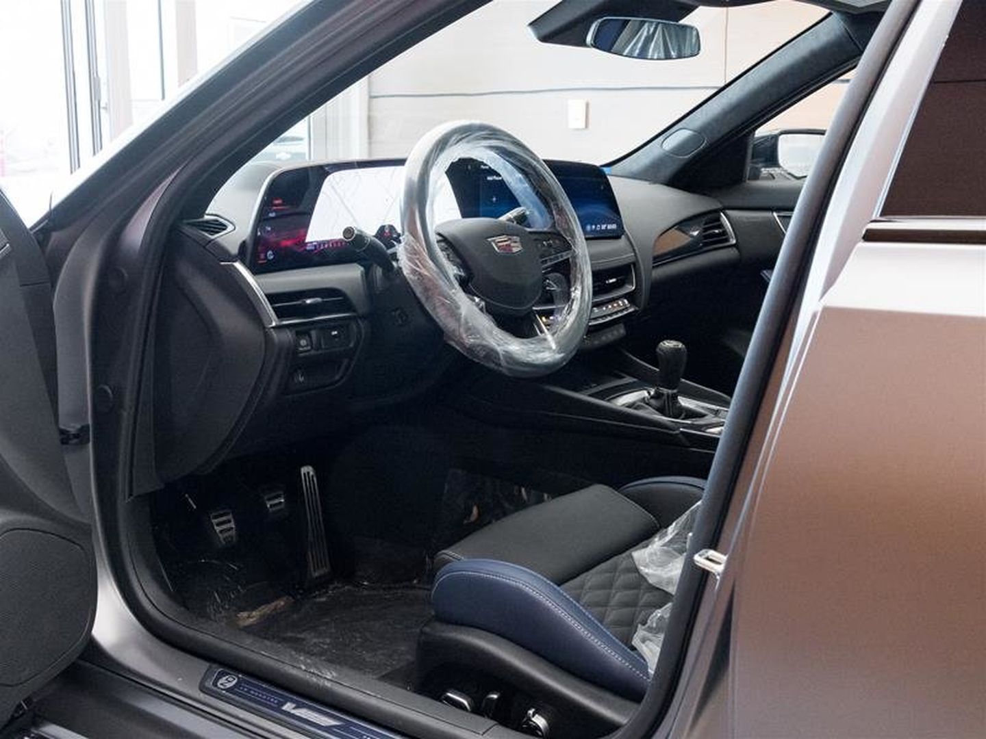 2026 Cadillac CT5-V Blackwing - interior view from the driver's side door showing the performance seats and manual transmission shifter - Applewood Cadillac - Cadillac new car dealership in Mississauga, Ontario