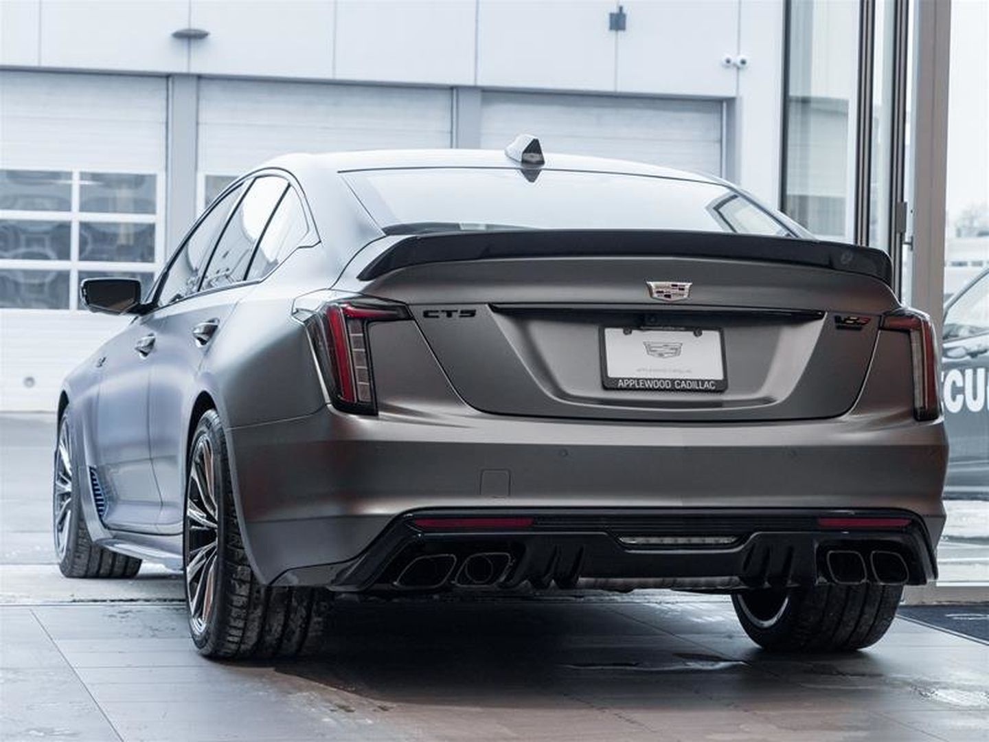 2026 Cadillac CT5-V Blackwing - rear view highlighting the quad exhaust tips, carbon fiber spoiler, and Blackwing badging - Applewood Cadillac - Cadillac new car dealership in Mississauga, Ontario