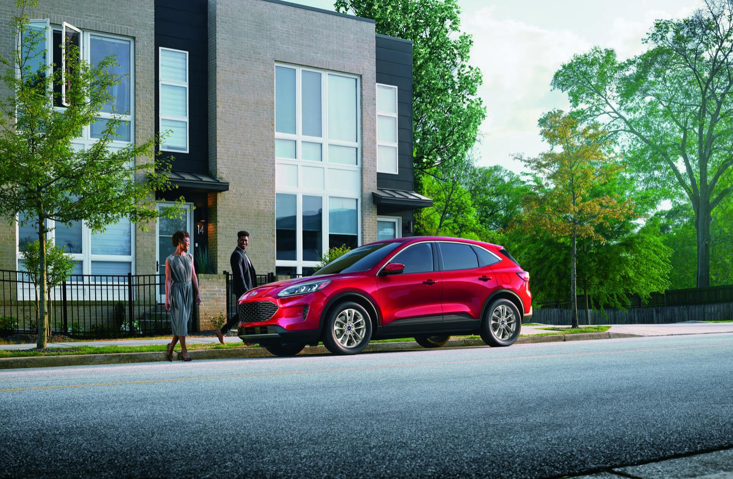 2022 Ford Escape - a red 2022 Ford Escape SE parked curbside in front of a modern brick townhome - Autopark Barrie - Used car dealership in Barrie, Ontario