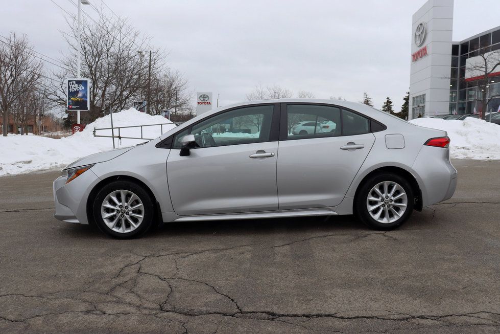 2020 Toyota Corolla - side profile view of a silver 2020 Toyota Corolla sedan in a dealership lot - Autopark Brampton - Used car dealership in Brampton, Ontario