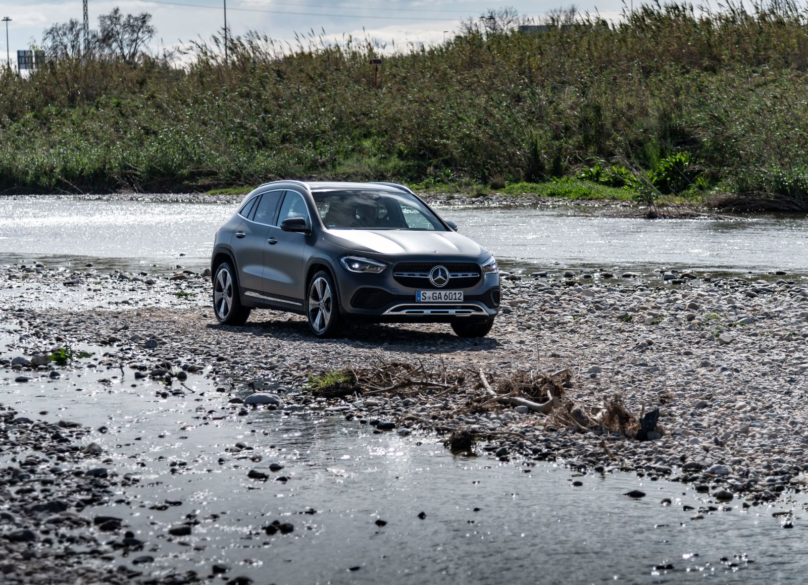 2026 Mercedes-Benz GLA - front view of a matte grey 2026 Mercedes-Benz GLA parked on a rocky riverbed - Mercedes-Benz Brampton - Mercedes-Benz new car dealership in Brampton, Ontario