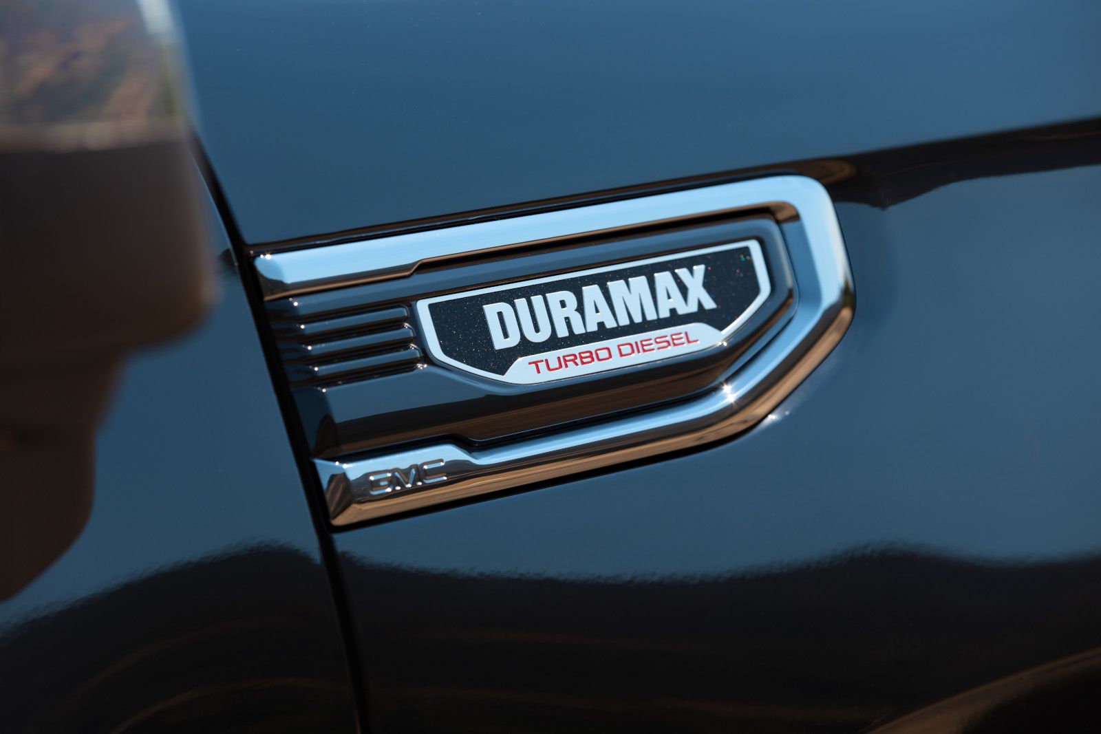 2026 GMC Sierra HD - close-up of the Duramax Turbo Diesel badge on a black GMC Sierra - Humberview Chevrolet, Buick, GMC - New car dealership in Toronto, Ontario