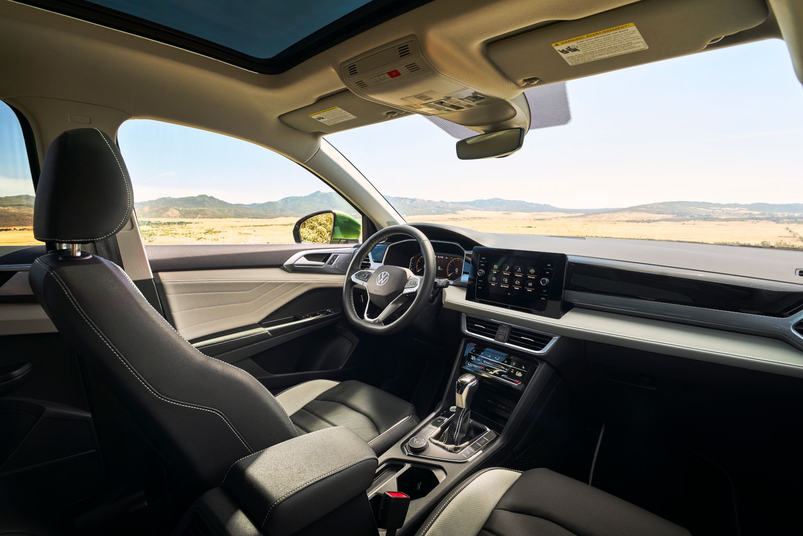 2026 Volkswagen Taos - interior view of the 2026 Volkswagen Taos dashboard, steering wheel, and infotainment system from the passenger side - Volkswagen Mid-Town Toronto - New car dealership in Toronto, Ontario
