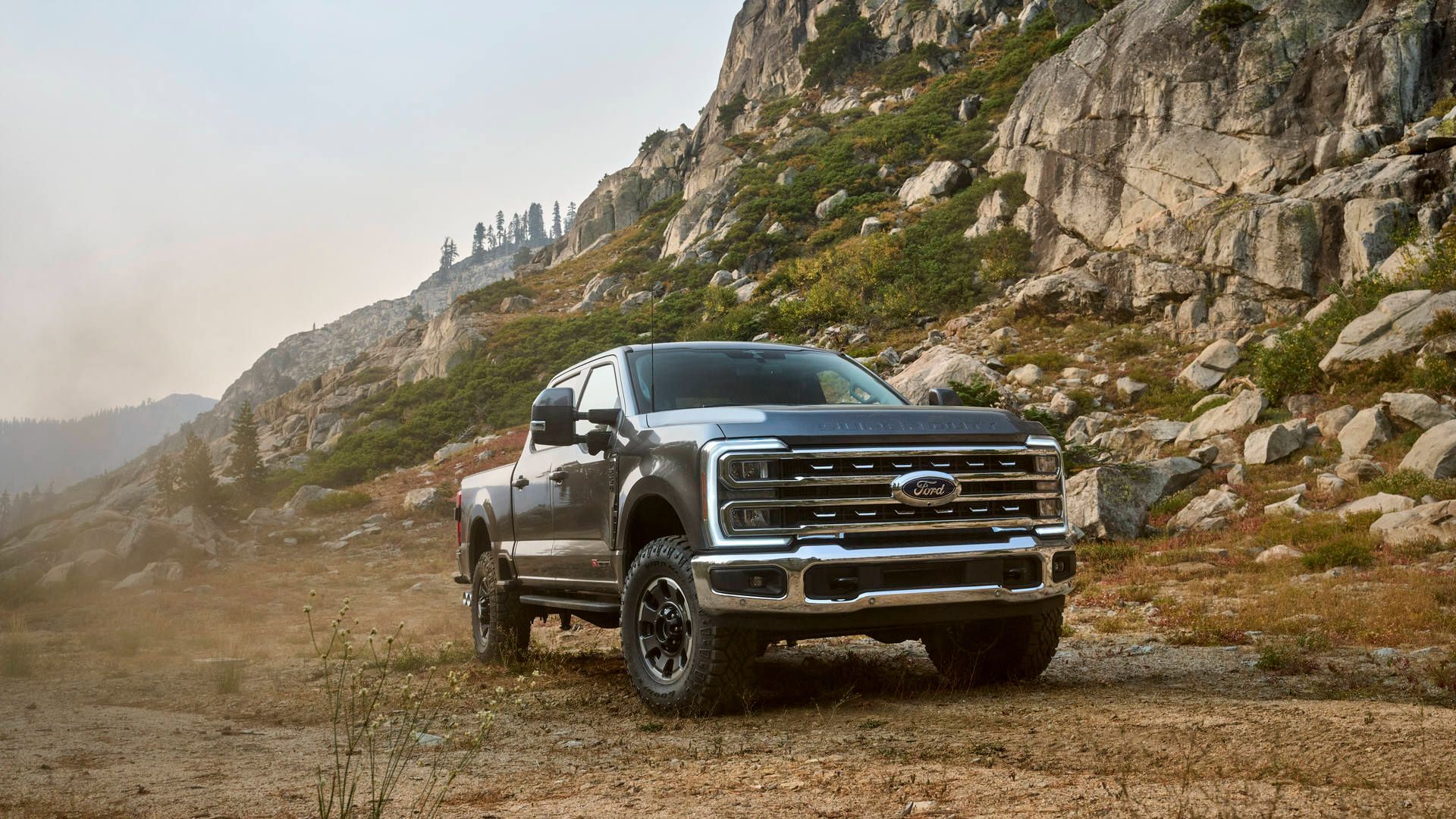 2026 Ford F-250 Tremor - a grey 2026 Ford F-250 Tremor with the off-road package parked on a rocky mountain trail - Humberview Group - New car dealerships in Ontario