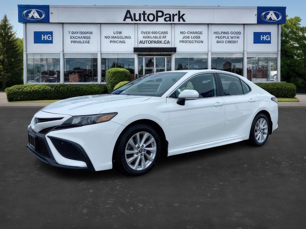2021 Toyota Camry - a white 2021 Toyota Camry parked in front of the dealership building - AutoPark Brampton - Used car dealership in Brampton, Ontario