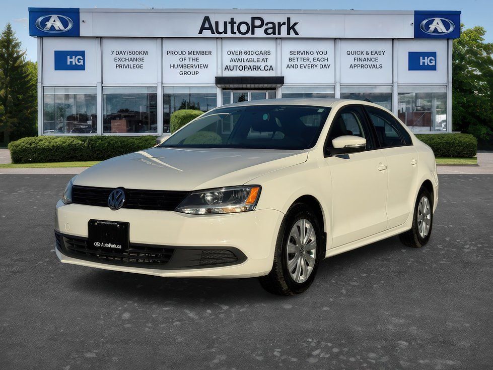 2014 Volkswagen Jetta - a white 2014 Volkswagen Jetta parked in front of the dealership building - AutoPark Brampton - Used car dealership in Brampton, Ontario