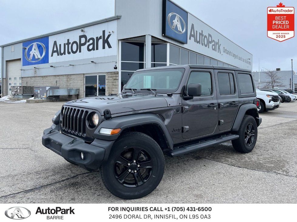 2021 Jeep Wrangler - side front view of a dark grey four-door Jeep Wrangler parked outside - AutoPark Barrie - Used car dealership in Barrie, Ontario