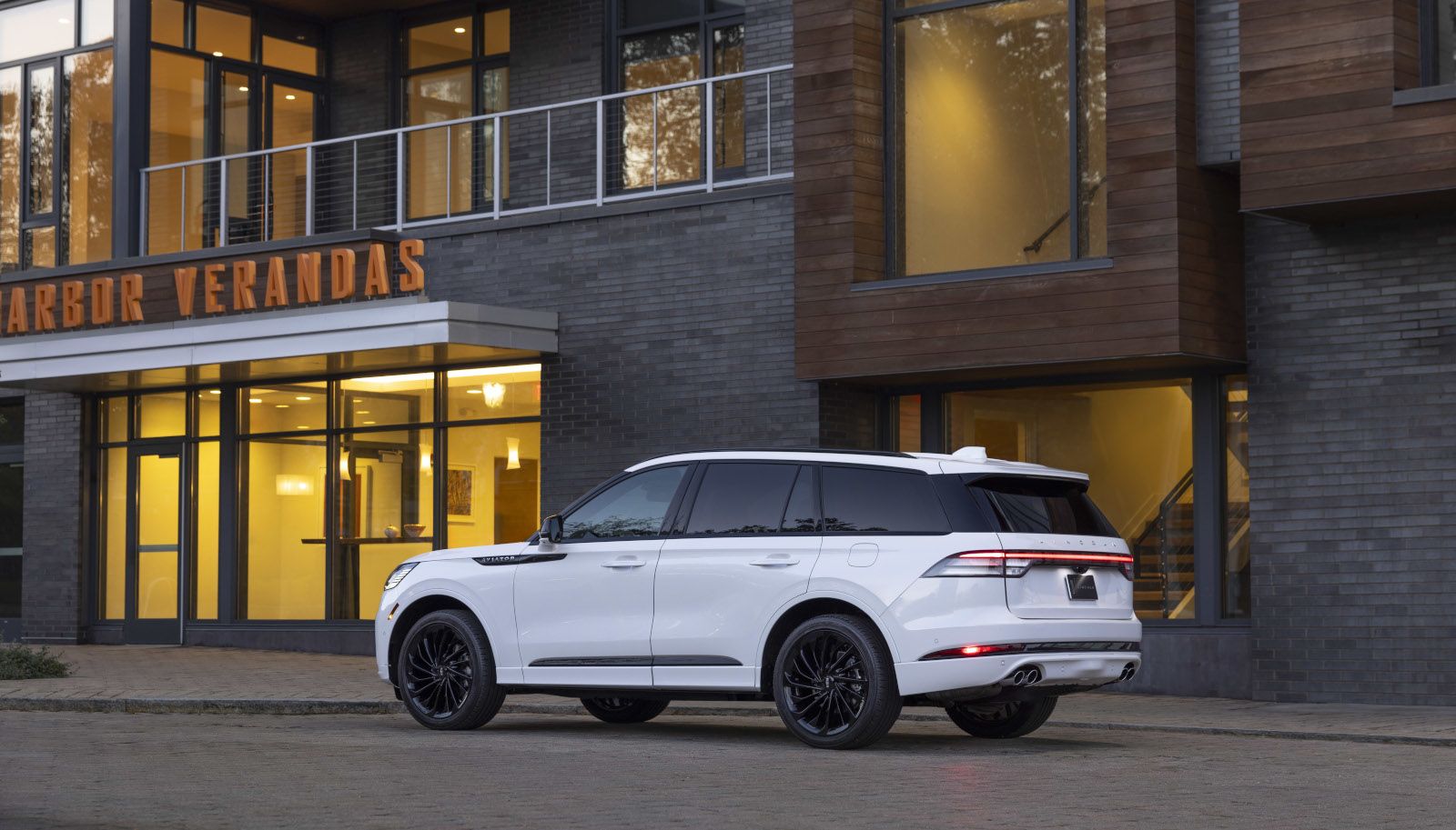 2026 Lincoln Aviator - rear view of a white 2026 Lincoln Aviator parked in front of a building at dusk - Mayfield Lincoln - New car dealership in Brampton, Ontario