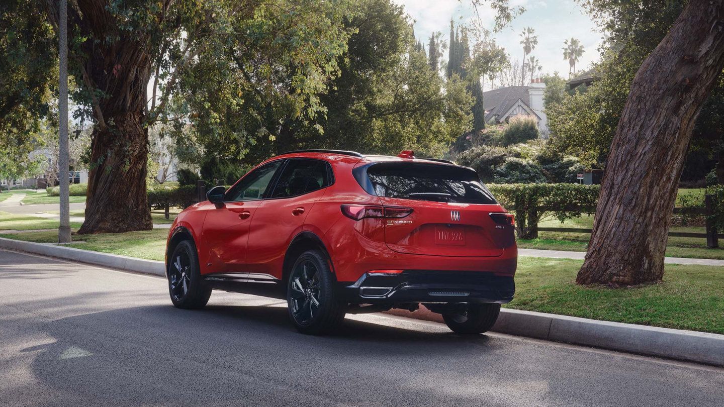 2026 Buick Envision - rear three-quarter view of a red 2026 Buick Envision parked on a residential street - Applewood Chevrolet, Buick, GMC - New car dealership in Mississauga, Ontario
