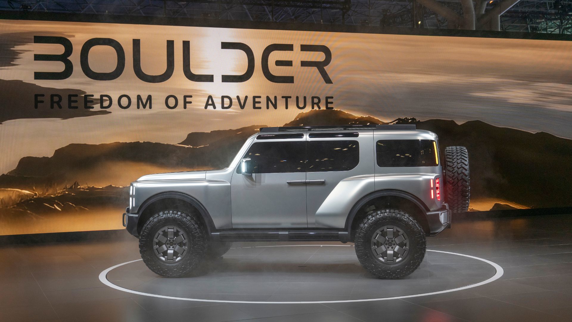 2026 Hyundai Boulder - side profile view of a silver 2026 Hyundai Boulder parked on a rotating stage - Cooksville Hyundai - Hyundai new car dealership in Mississauga, Ontario
