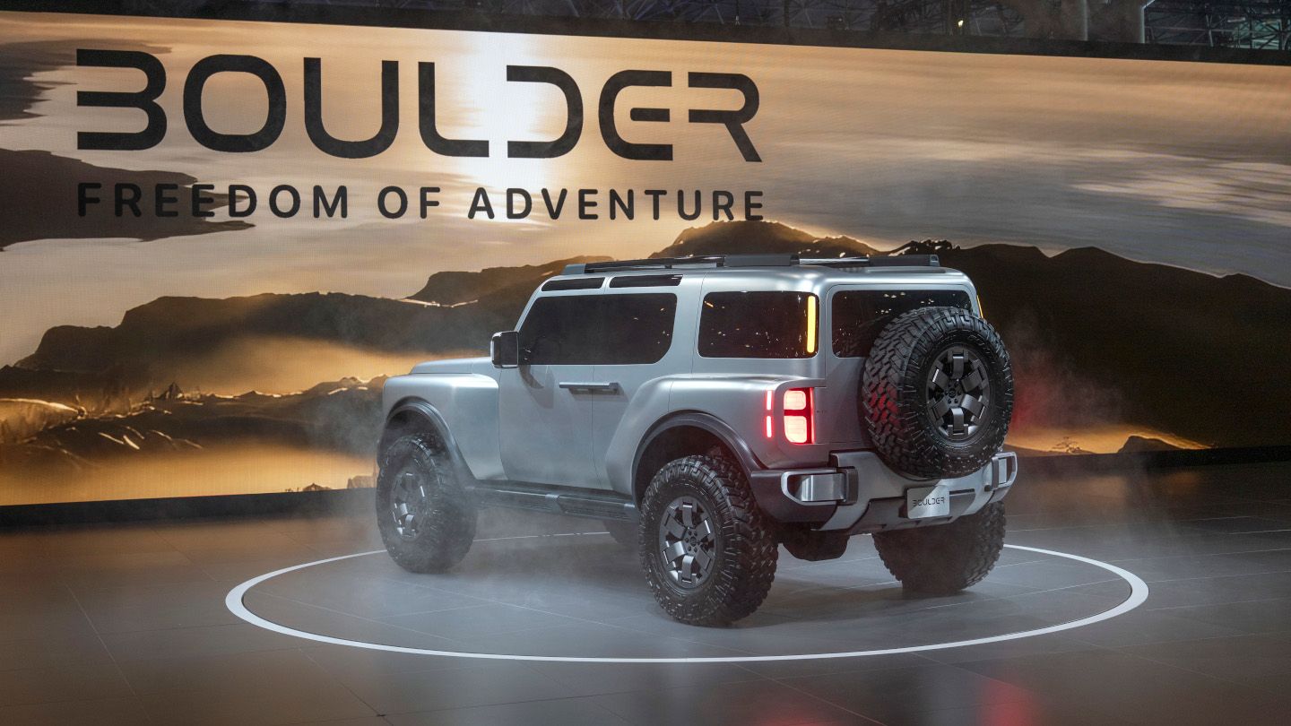 Hyundai Boulder - rear view of the silver 2026 Hyundai Boulder featuring the spare tire on a display turntable - Woodstock Hyundai - New car dealership in Woodstock, Ontario