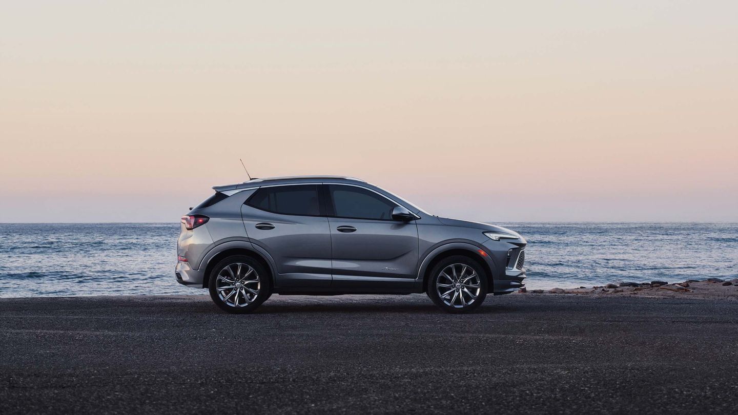2026 Buick Encore GX - side profile of a silver 2026 Buick Encore GX parked by the ocean at sunset - Applewood Chevrolet Buick GMC - Buick new car dealership in Mississauga, Ontario