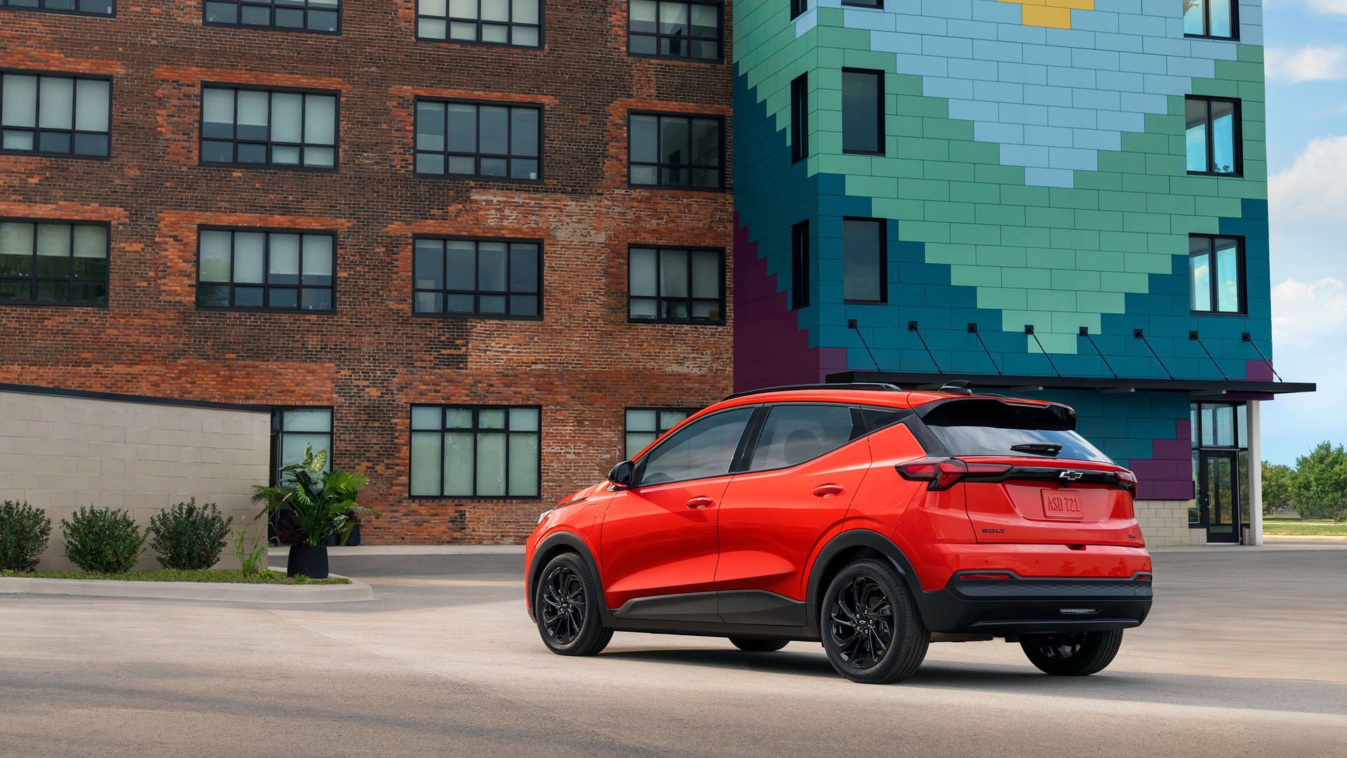 2026 Chevrolet Bolt - rear driver-side view of a red 2026 Chevrolet Bolt parked in front of a modern building - City Chevrolet Buick GMC - New car dealership in Toronto, Ontario