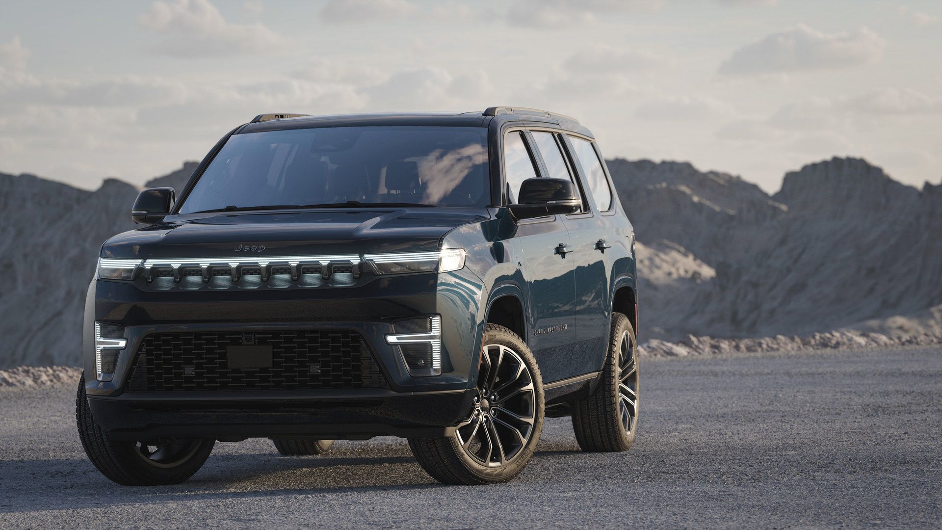 2026 Jeep Grand Wagoneer - a dark blue 2026 Jeep Grand Wagoneer parked in a rocky desert landscape - Humberview Group - New car dealerships in Ontario