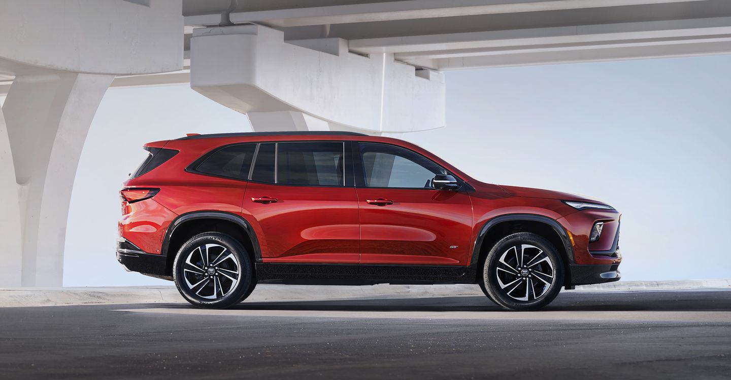 2026 Buick Enclave - a red 2026 Buick Enclave ST shown from the side parked under a white bridge structure - Humberview Group - New car dealerships in Ontario