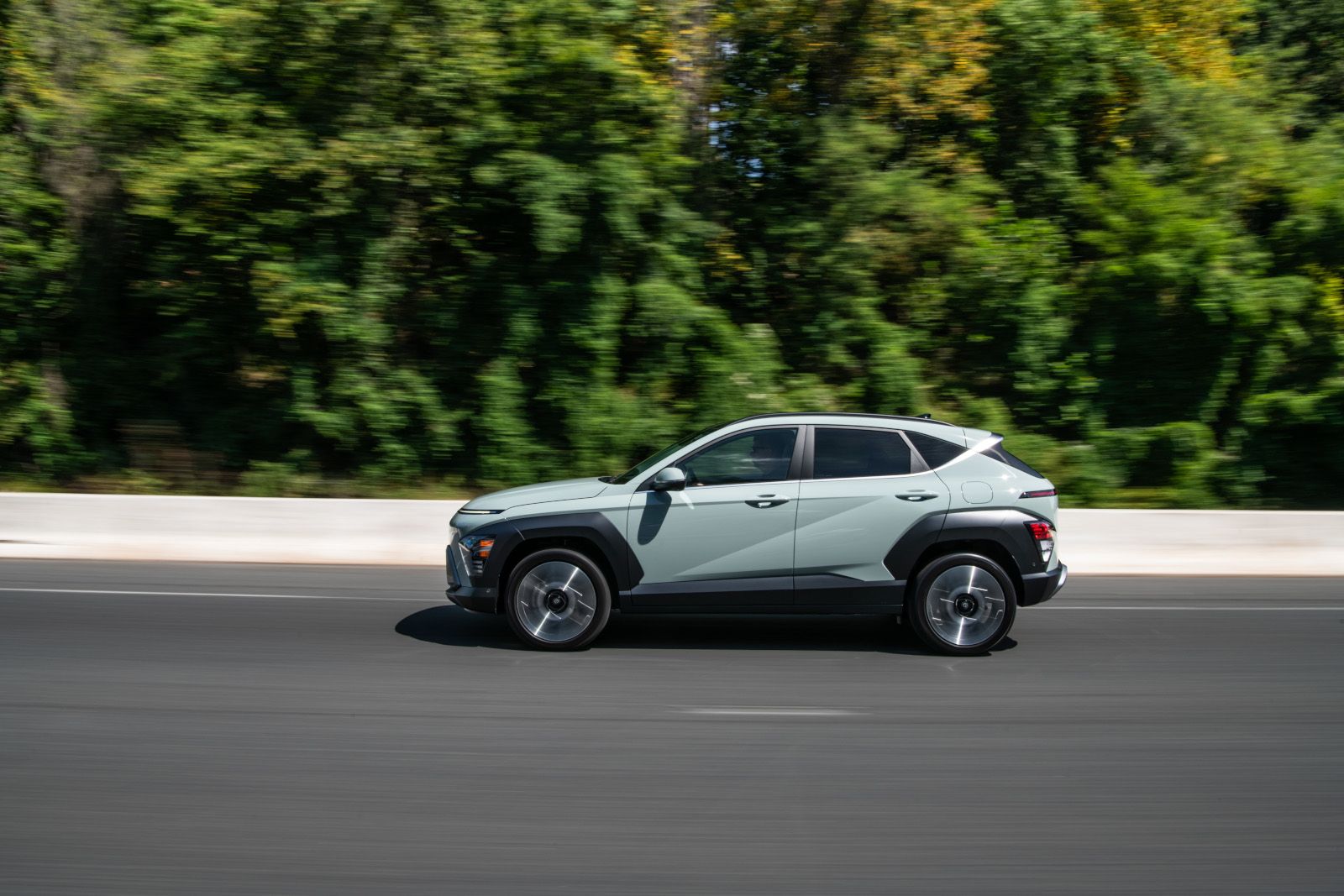 2026 Hyundai Kona - a light green 2026 Hyundai Kona driving along a highway - Humberview Group - New car dealerships in Ontario