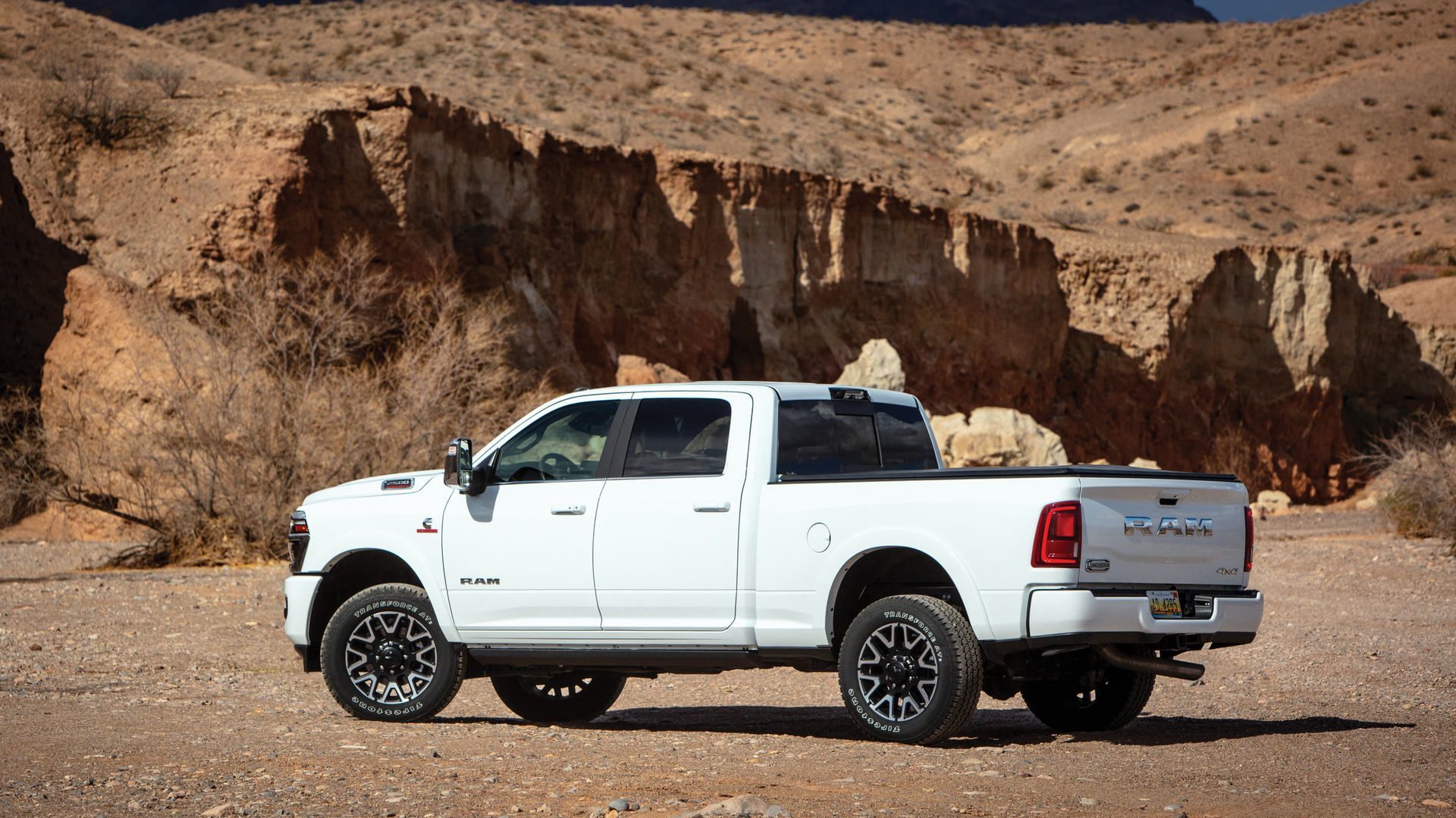 2026 RAM 2500 Longhorn Limited - side profile view of a white 2026 RAM 2500 Longhorn Limited parked in a desert canyon - Cooksville Dodge - RAM car dealership in Mississauga, Ontario