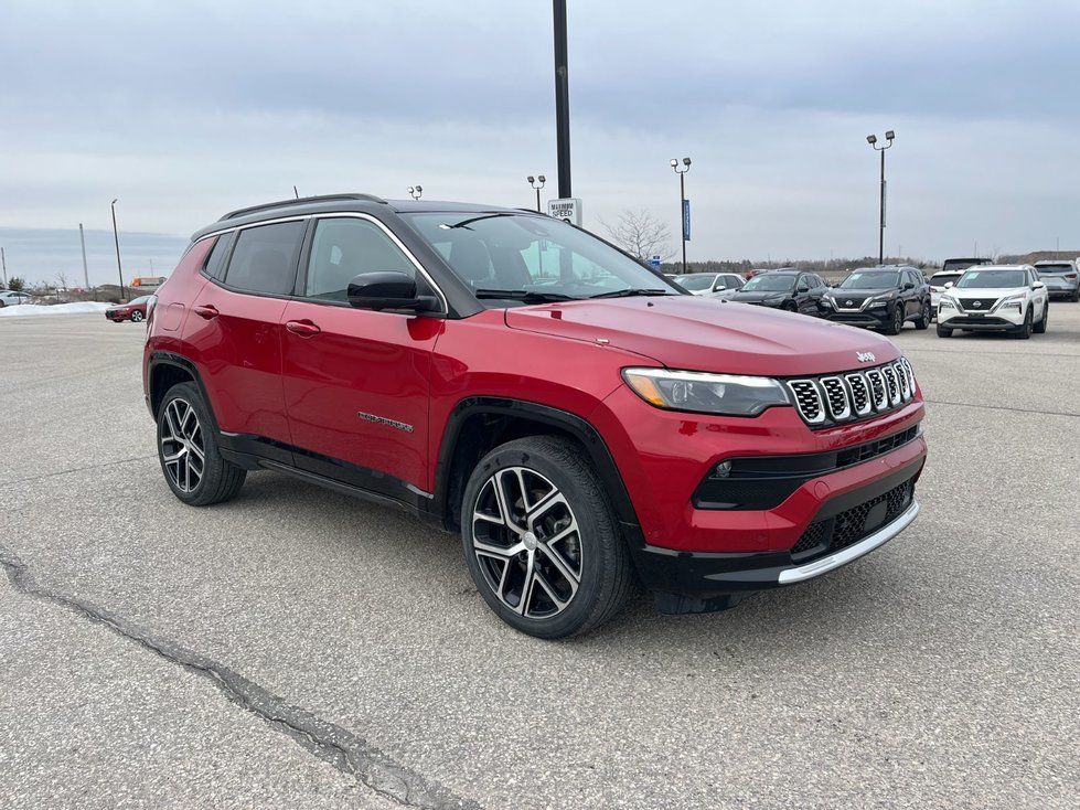 2024 Jeep Compass - front three-quarter view of a red 2024 Jeep Compass in a parking lot - AutoPark Barrie - Used car dealership in Barrie, Ontario
