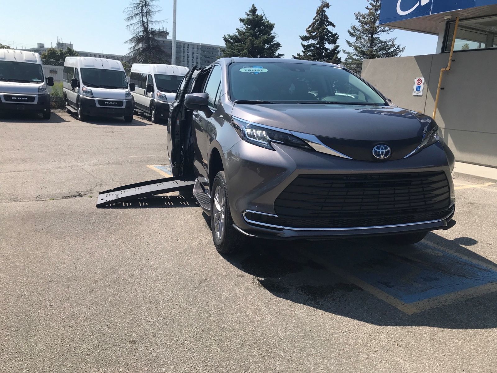 2026 Toyota Sienna - front angle view of a gray 2026 Toyota Sienna with a side-entry wheelchair ramp deployed - Humberview Mobility - Accessible car dealership in Toronto, Ontario