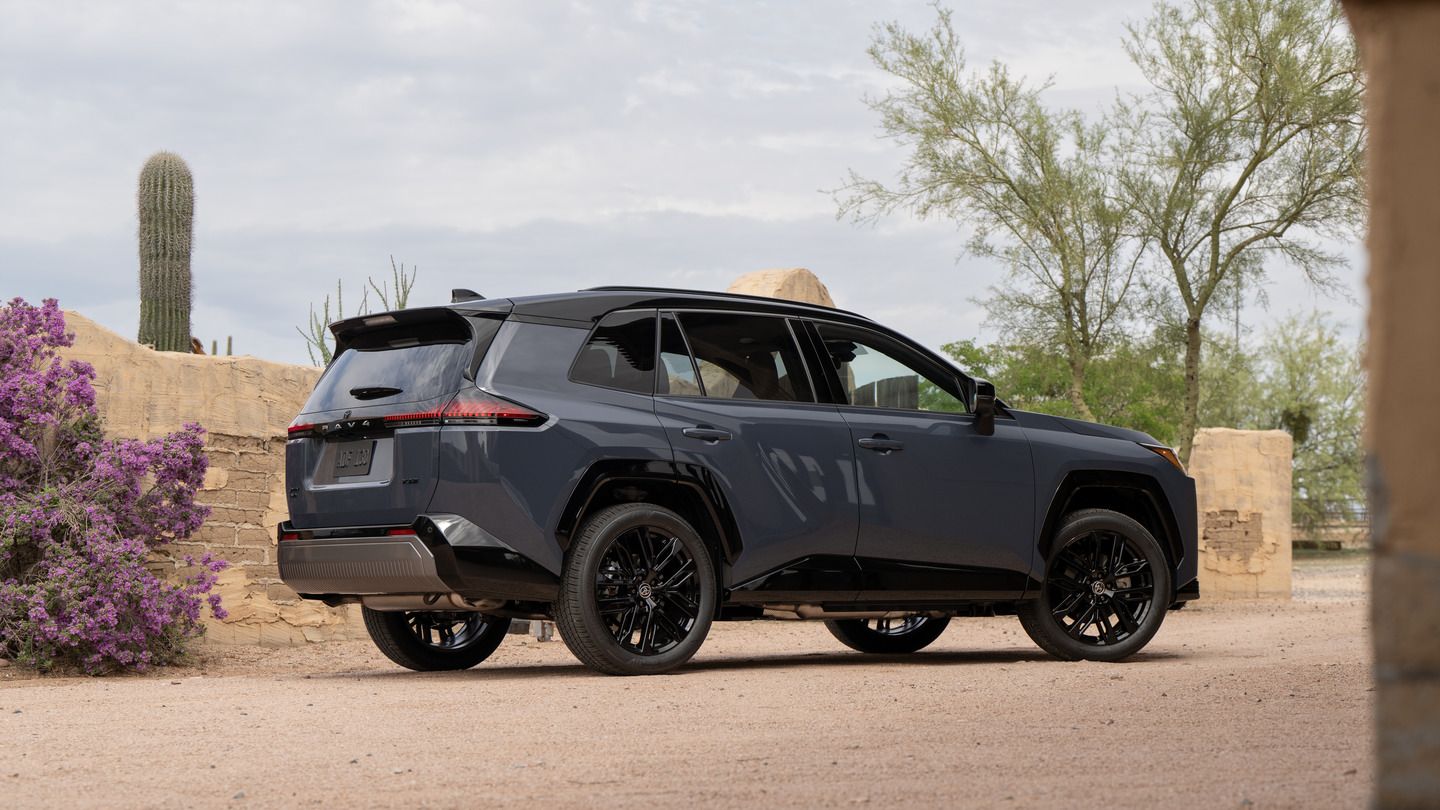 2026 Toyota RAV4 PHEV XSE - Rear three-quarter view of a Storm Cloud 2-tone Toyota RAV4 PHEV parked on a desert gravel path - Orangeville Toyota - New car dealership in Orangeville, Ontario