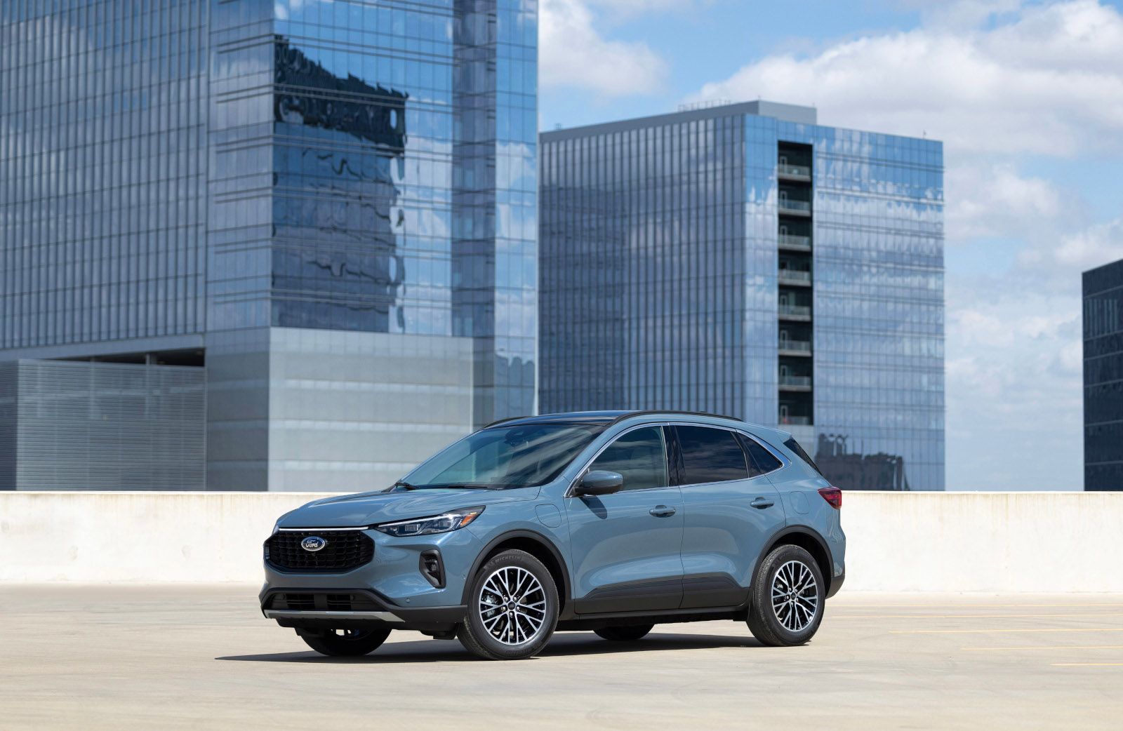 2026 Ford Escape - A Vapor Blue Ford Escape Plug-In Hybrid parked on a rooftop lot with city buildings in the background - Humberview Group - Ford new car dealerships in Ontario