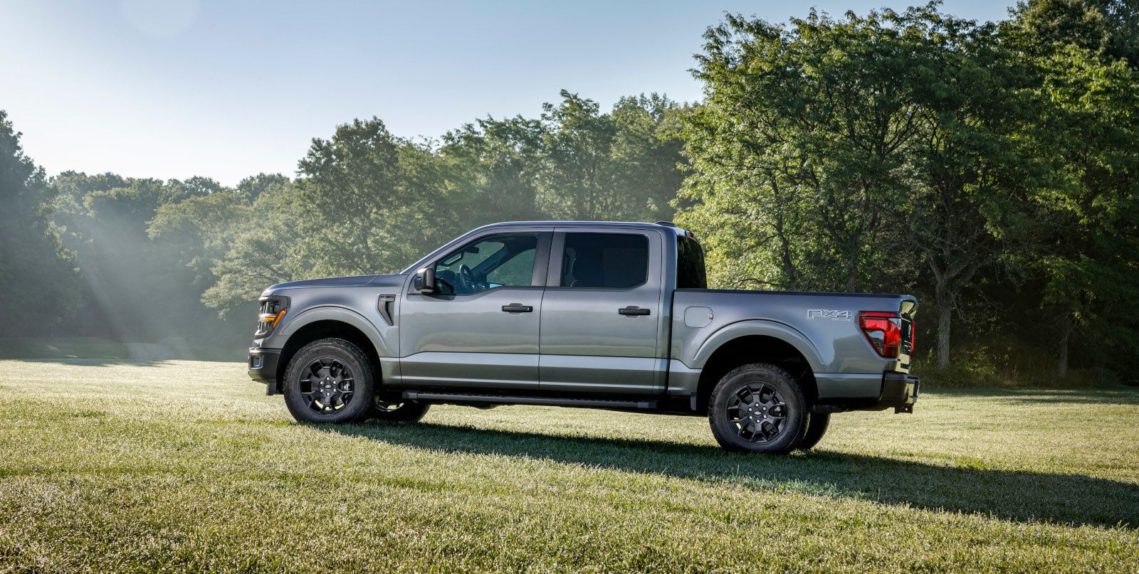 2026 Ford F-150 STX - side view of a grey Ford F-150 parked on a grassy field - Bayfield Ford - New car dealership in Barrie, Ontario