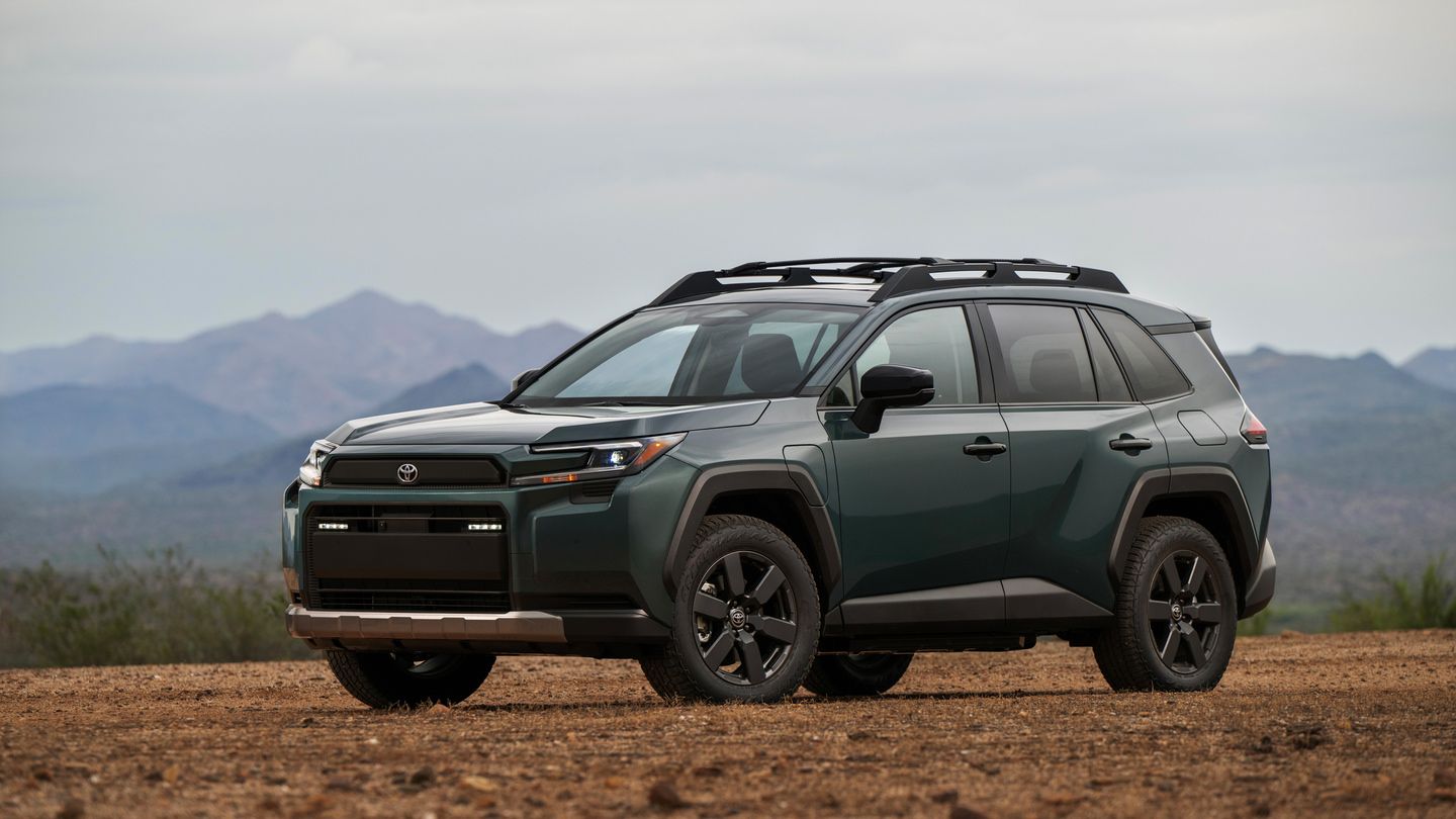 2026 Toyota RAV4 PHEV - Front three-quarter view of a dark green Toyota RAV4 PHEV Woodland edition parked on a dirt hilltop - Goderich Toyota - New car dealership in Goderich, Ontario