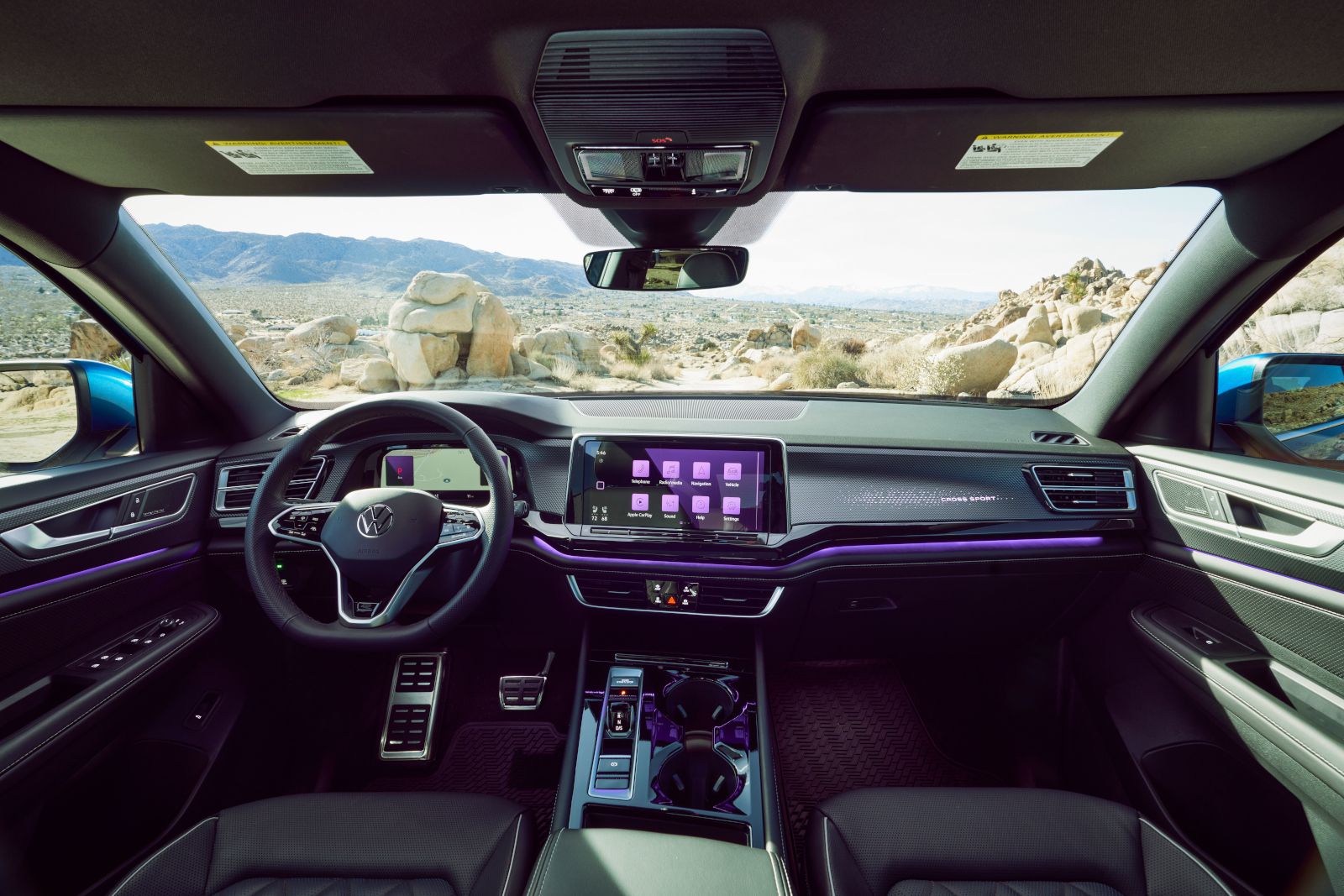 2026 Volkswagen Atlas Cross Sport - interior view of the 2026 Volkswagen Atlas Cross Sport dashboard, steering wheel, and infotainment screen with purple ambient lighting - Humberview Volkswagen - New car dealership in Toronto, Ontario