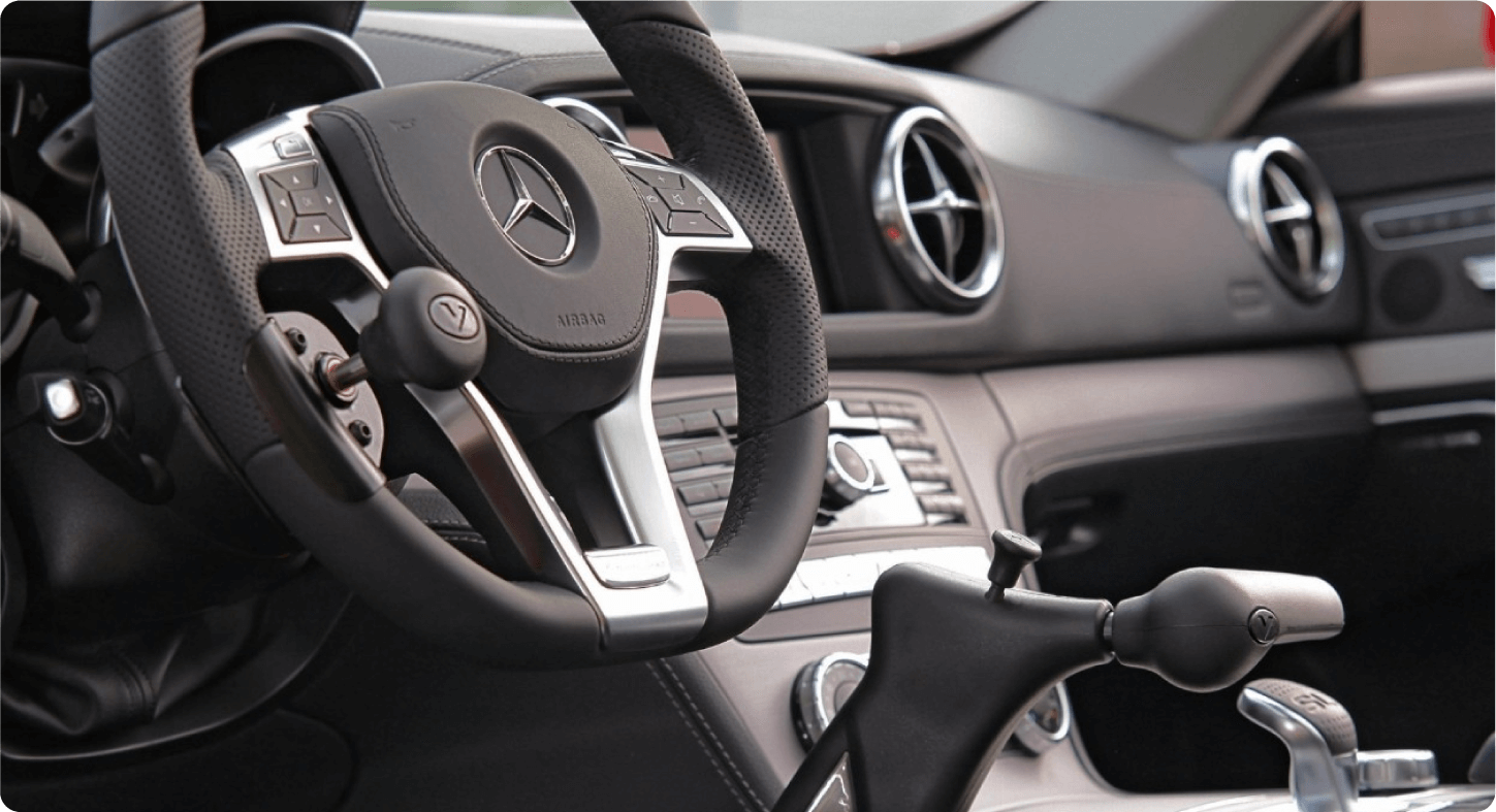 Mercedes-Benz - close-up interior view of a Mercedes-Benz steering wheel equipped with a driving hand control system - Courtland Mobility - Wheelchair accessible car dealership in Burlington, Ontario