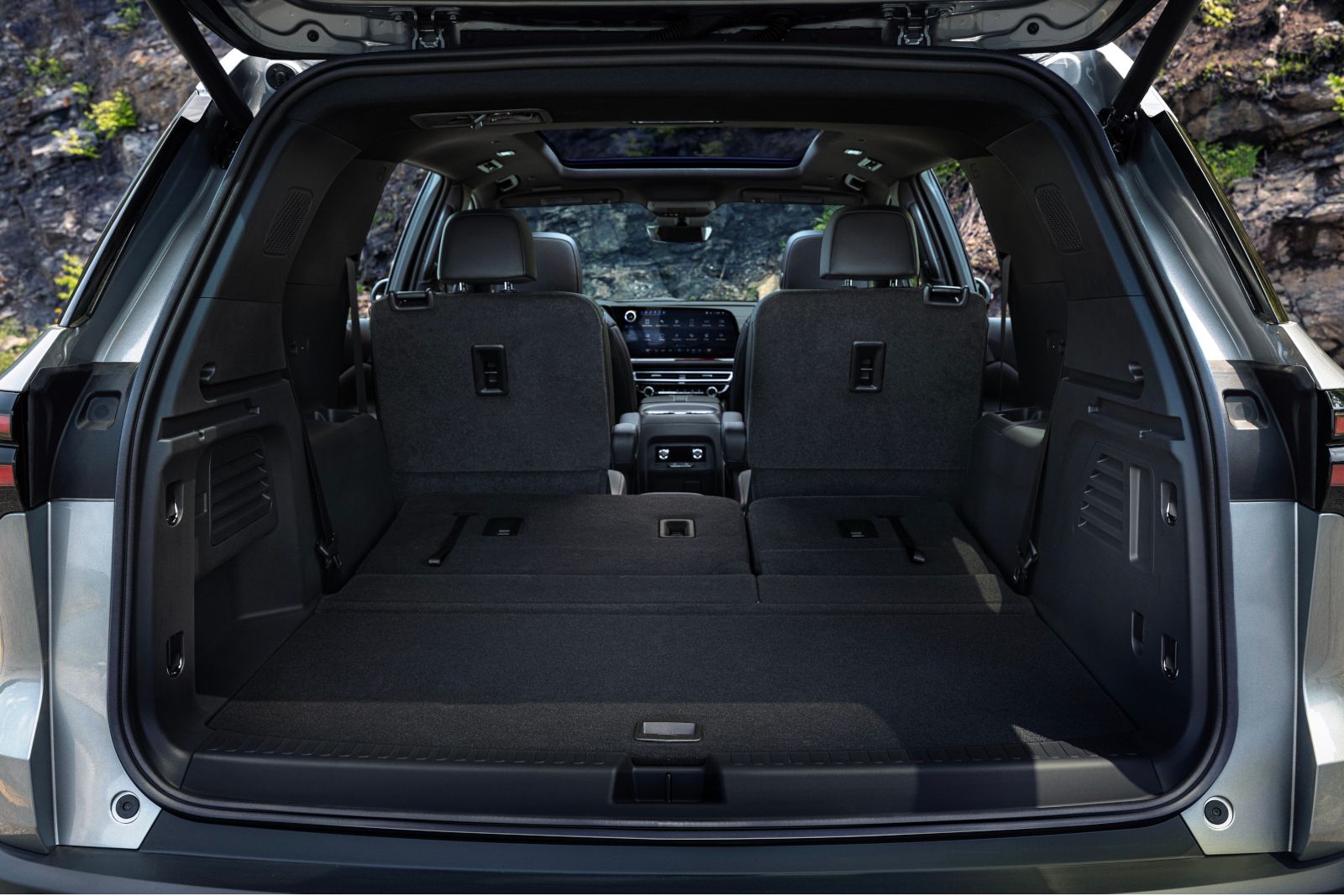 2026 Chevrolet Traverse - view from the open tailgate showing the spacious cargo area with the third-row seats folded flat - Applewood Chevrolet, Buick, GMC - New car dealership in Mississauga, Ontario
