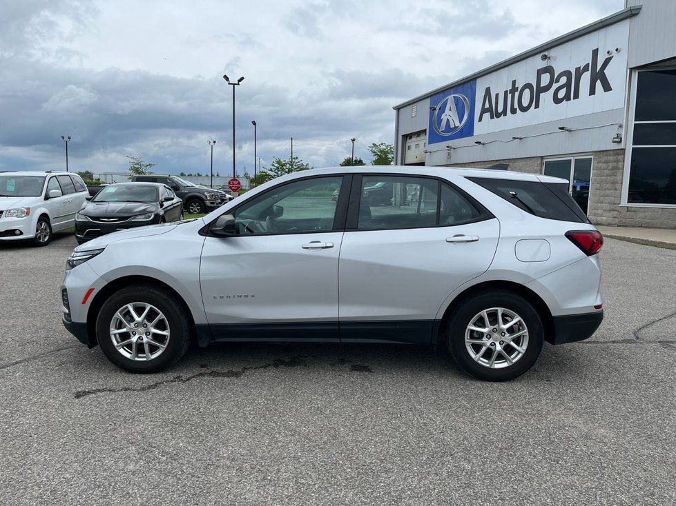 Chevrolet Equinox - a side profile view of a silver Chevrolet Equinox parked in a dealership lot - AutoPark Barrie - Used car dealership in Barrie, Ontario