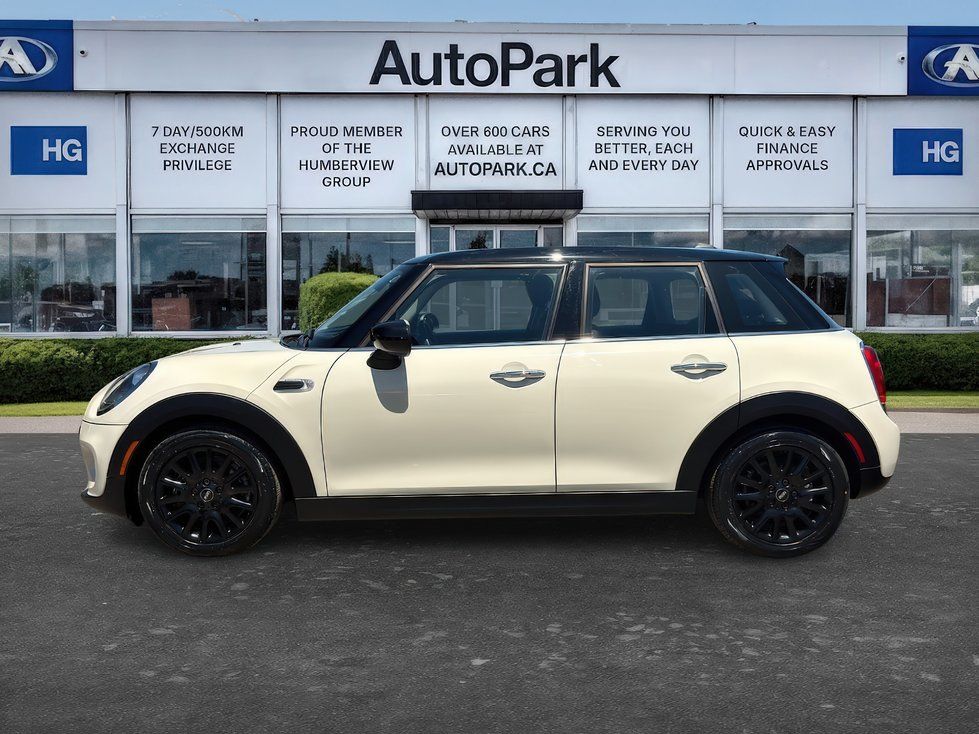 MINI Cooper - passenger side profile view of a cream and black MINI Cooper - AutoPark Brampton - Used car dealership in Brampton, Ontario
