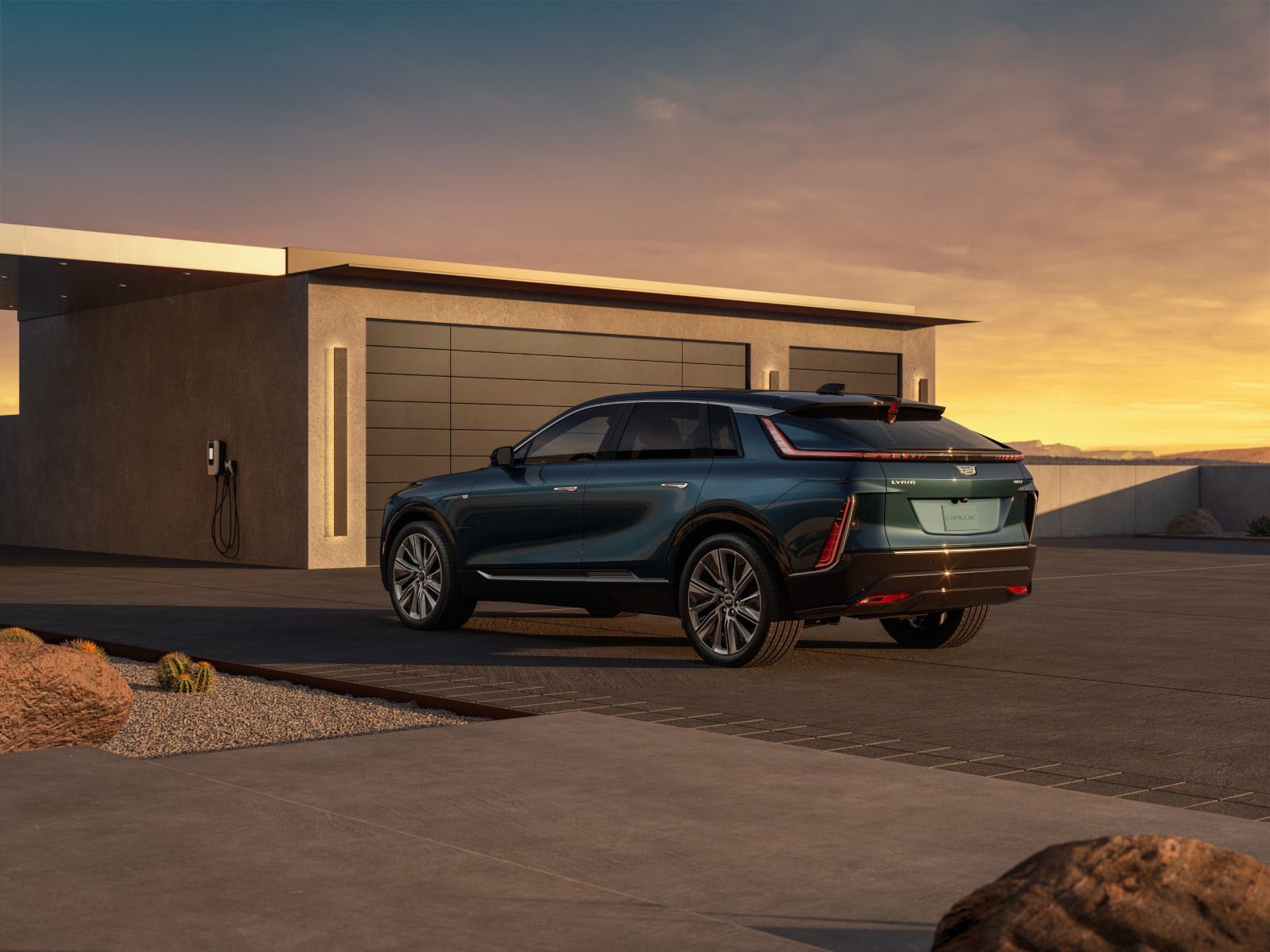2026 Cadillac Lyriq - a dark green 2026 Cadillac Lyriq parked outside a modern garage at sunset - City Cadillac - New car dealership in Toronto, Ontario