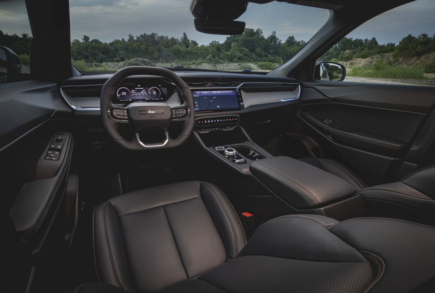 2026 Jeep Cherokee - interior view of the 2026 Jeep Cherokee's black leather front seats, dashboard, and infotainment screen - Cooksville Dodge - Jeep new car dealership in Mississauga, Ontario