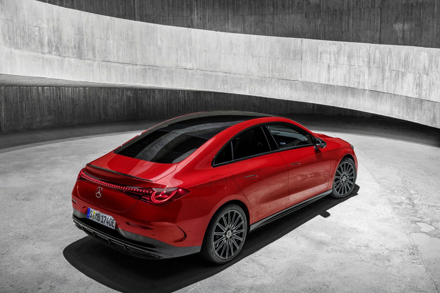 2027 Mercedes-Benz CLA EV - rear three-quarter view of a red 2027 Mercedes-Benz CLA EV parked in a modern concrete setting - Mercedes-Benz Brampton - New car dealership in Brampton, Ontario