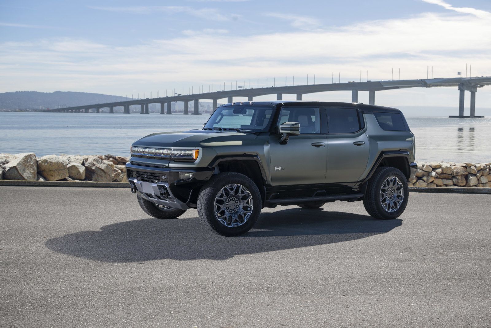 2026 GMC Hummer EV SUV - Front three-quarter view of a matte green GMC Hummer EV SUV - Applewood Chevrolet, Buick, GMC - New car dealership in Mississauga, Ontario