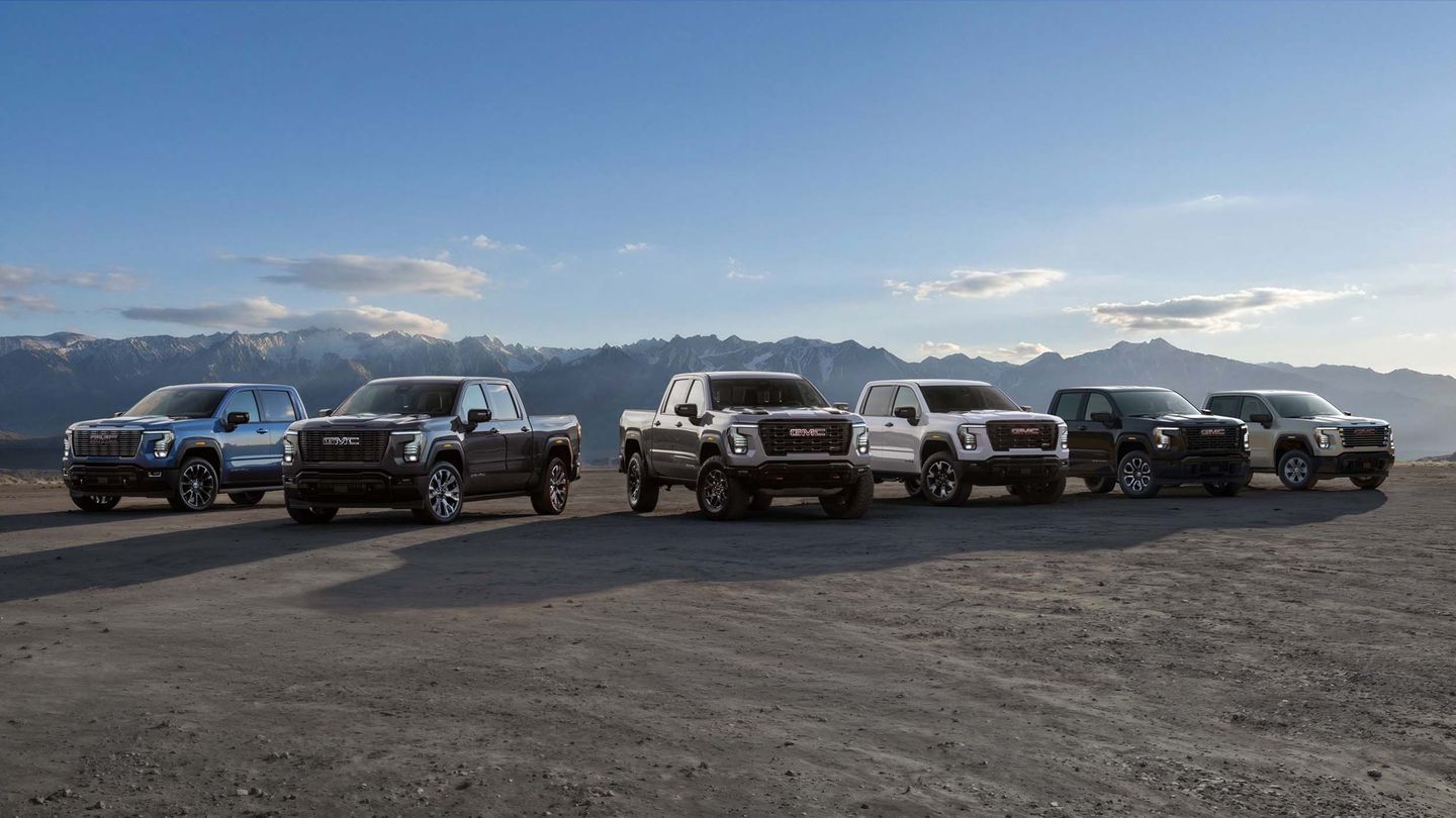 2027 GMC Sierra - lineup of six 2027 GMC Sierra pickup trucks parked in an open landscape with mountains in the background - Humberview Chevrolet, Buick, GMC - New car dealership in Toronto, Ontario