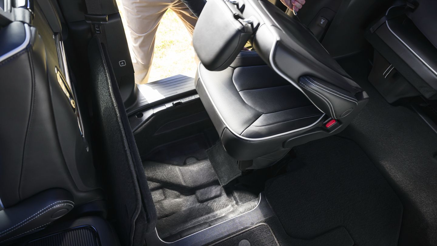 2027 Chrysler Pacifica - interior view of a 2027 Chrysler Pacifica Stow 'n Go seat folding into floor storage - Cooksville Chrysler, Jeep, Dodge, RAM - Chrysler new car dealership in Mississauga, Ontario