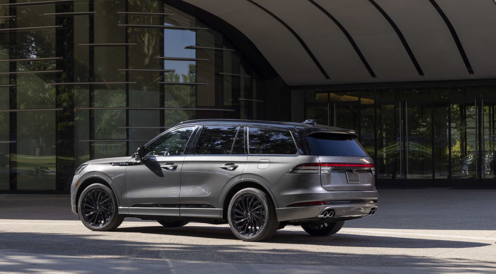 2026 Lincoln Aviator - a grey 2026 Lincoln Aviator parked outside a modern glass building - Mayfield Lincoln - Lincoln new car dealership in Brampton, Ontario