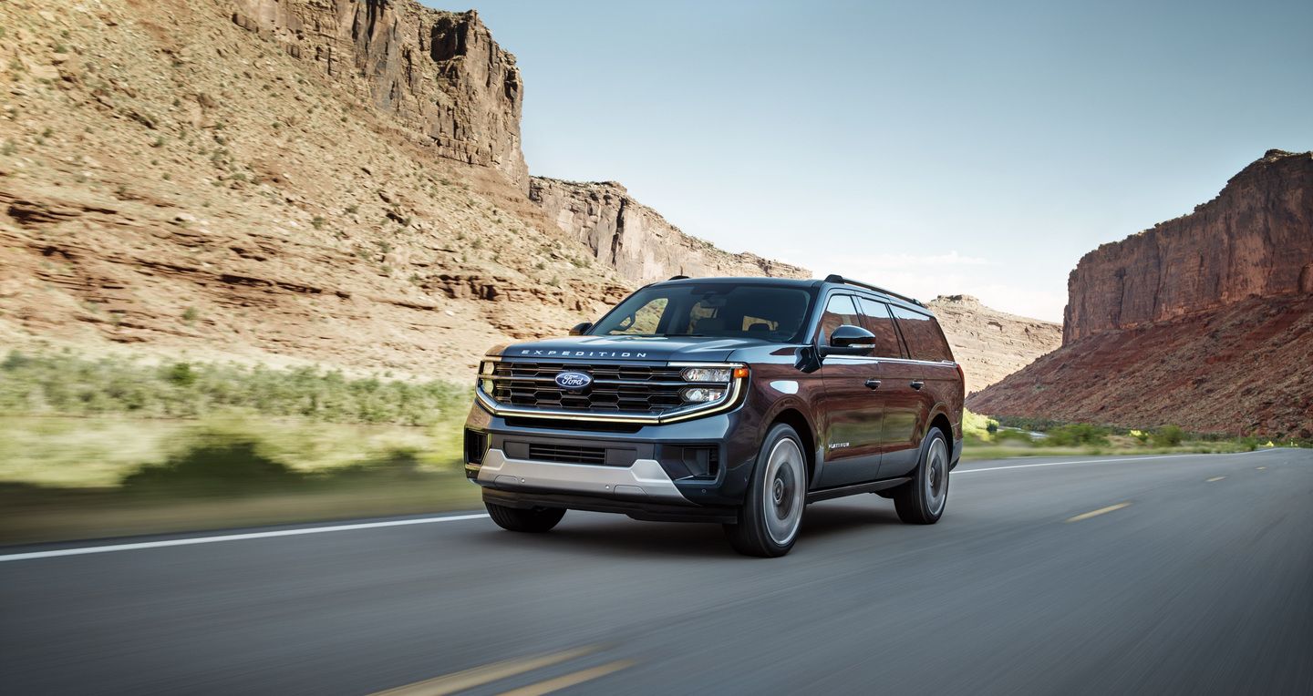 2026 Ford Expedition - a blue 2026 Ford Expedition SUV driving fast past a canyon on the highway - Bayfield Ford - Ford car dealership in Barrie, ON