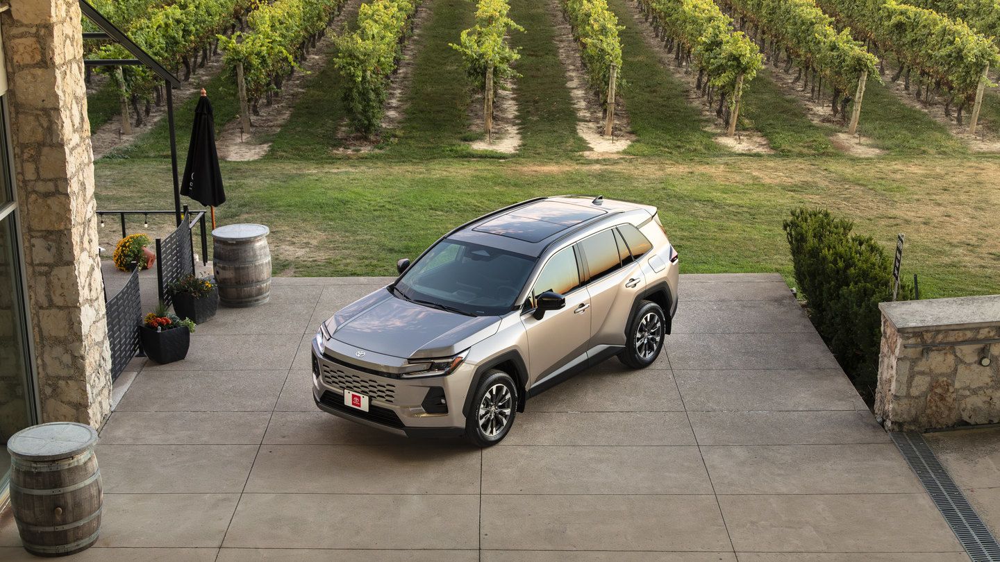 2026 Toyota RAV4 - high angle front-three-quarter view of a bronze 2026 Toyota RAV4 parked on a stone patio near a vineyard - Goderich Toyota - Toyota New car dealership in Goderich, Ontario
