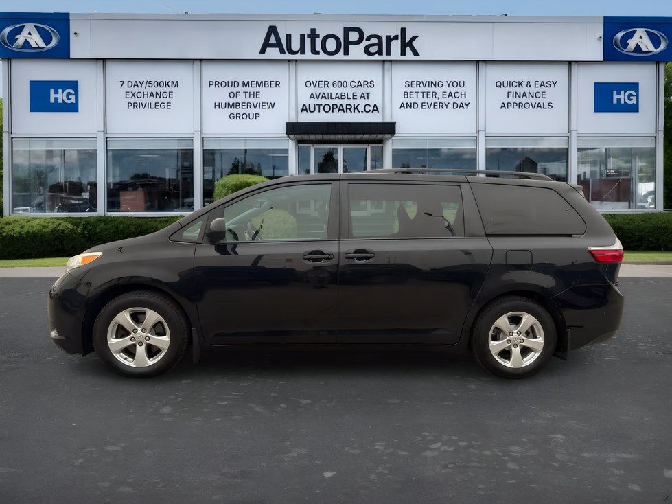 Toyota Sienna - side profile view of a black Toyota Sienna minivan parked outside - AutoPark Brampton - Used car dealership in Brampton, Ontario