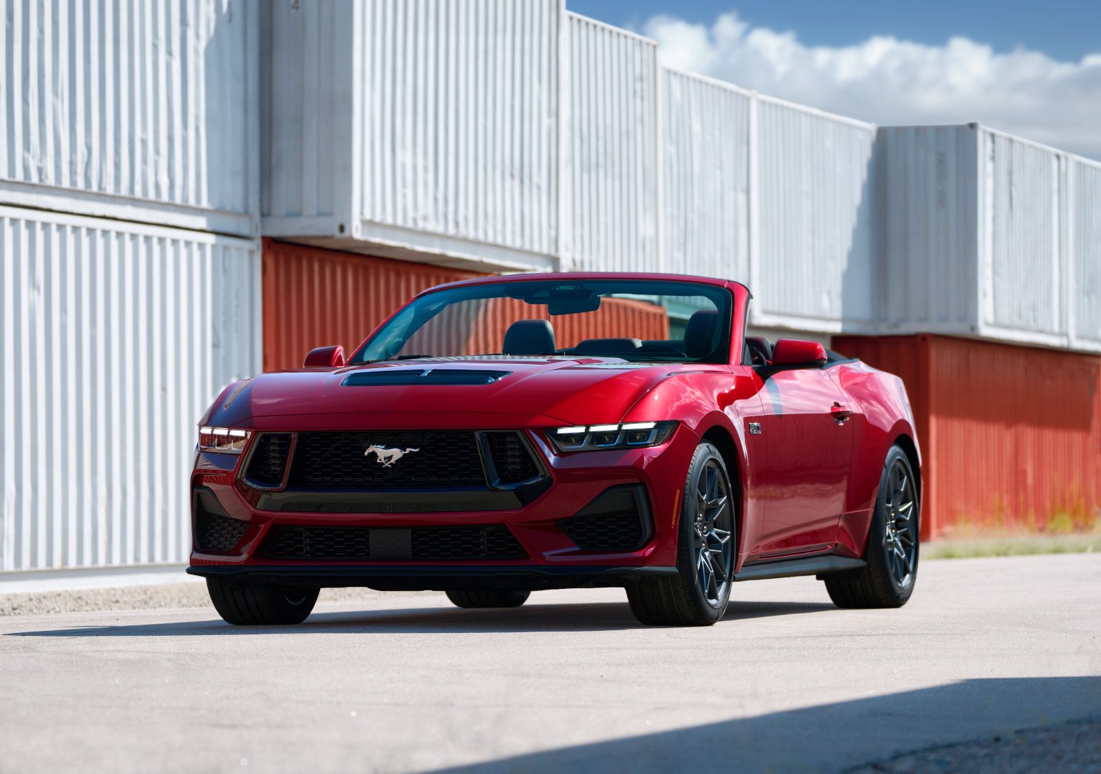 Ford Mustang - front view of a red Ford Mustang GT convertible parked near cargo containers - AutoPark Barrie - Used car dealership in Barrie, Ontario