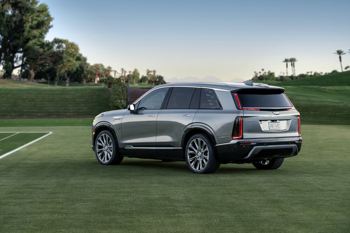 2026 Cadillac VISTIQ - rear three-quarter view of a silver 2026 Cadillac VISTIQ parked on a golf course - Applewood Cadillac - Cadillac new car dealership in Mississauga, Ontario