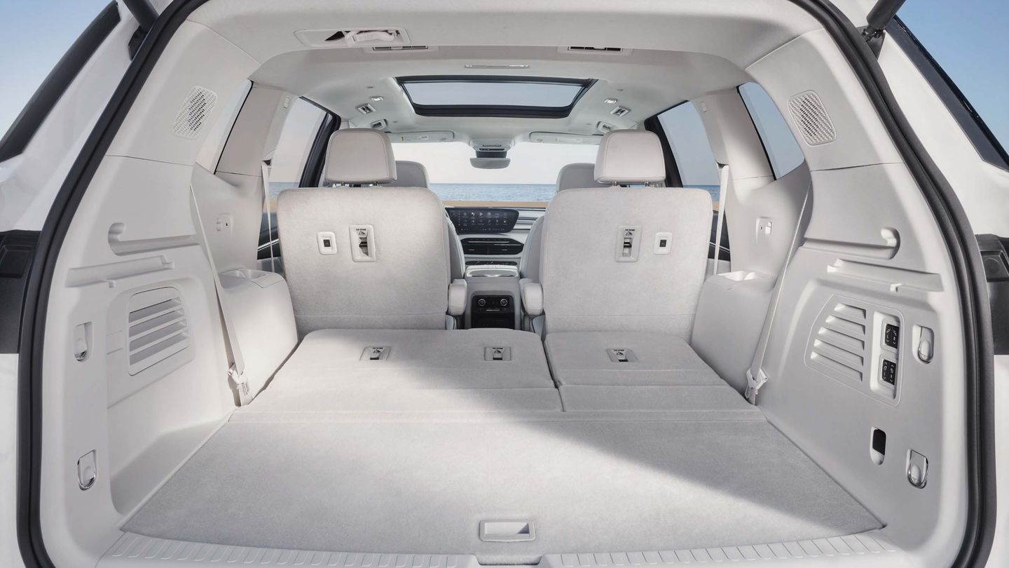 2026 Buick Enclave - A rear interior view looking forward showing the folded second-row and third-row seats and large cargo area in a white 2026 Buick Enclave - City Chevrolet, Buick, GMC - Buick new car dealership in Toronto, Ontario